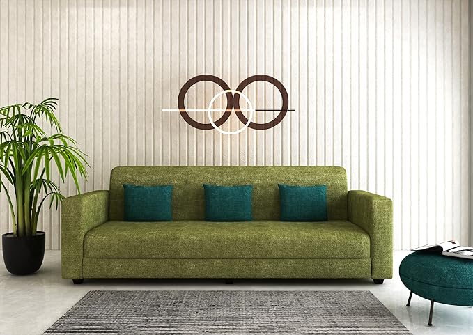 Olive green sofa inside room with a plant