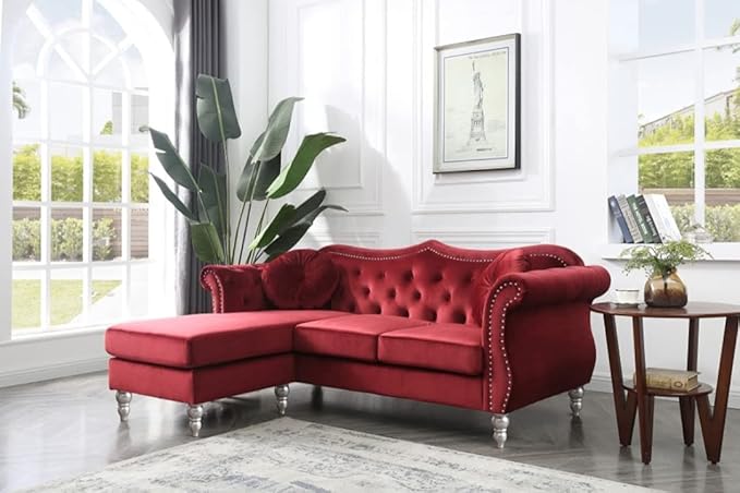 Burgundy sofa in room with table and carpet