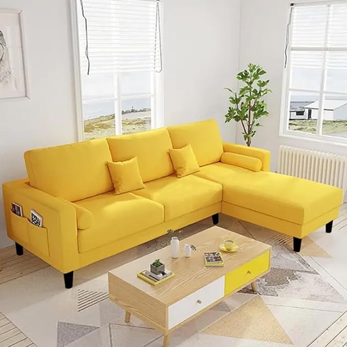 yellow sofa with pillows in room with table